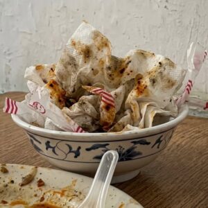 Is putting used tissues on a plate impolite, or does it make it easier for the restaurant to clear tables?