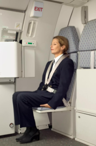Here’s Why Flight Attendants Sit On Their Hands During Takeoff And Landing